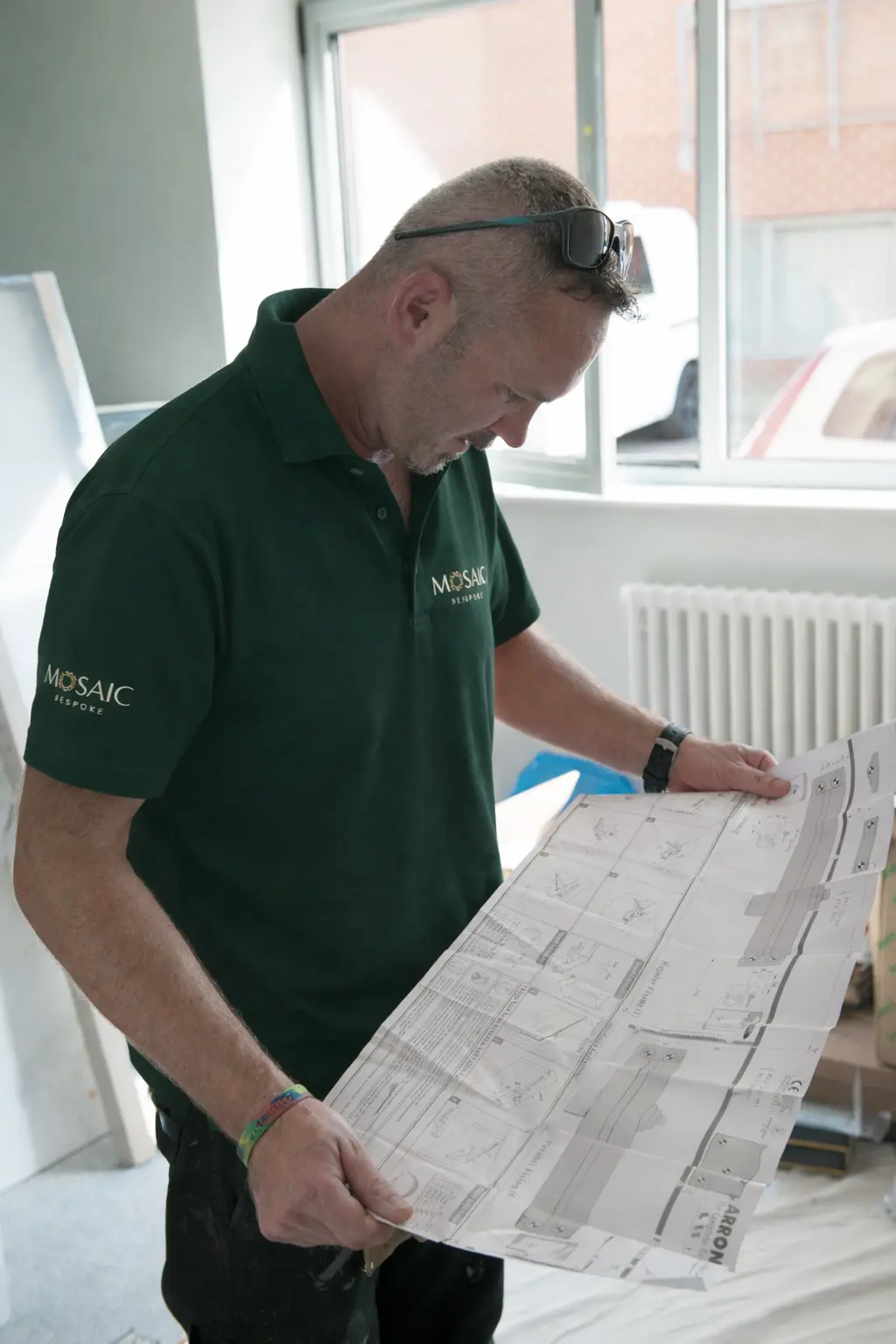 Mosaic Bespoke site manager reviewing construction drawings on site