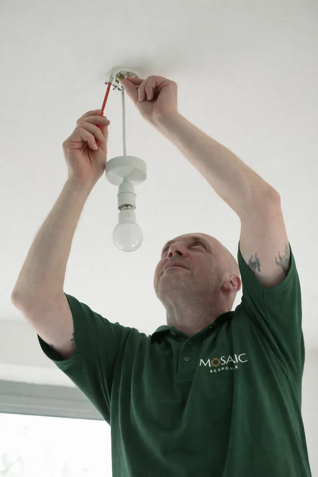 Mosaic Bespoke electrician second-fixing a pendant light