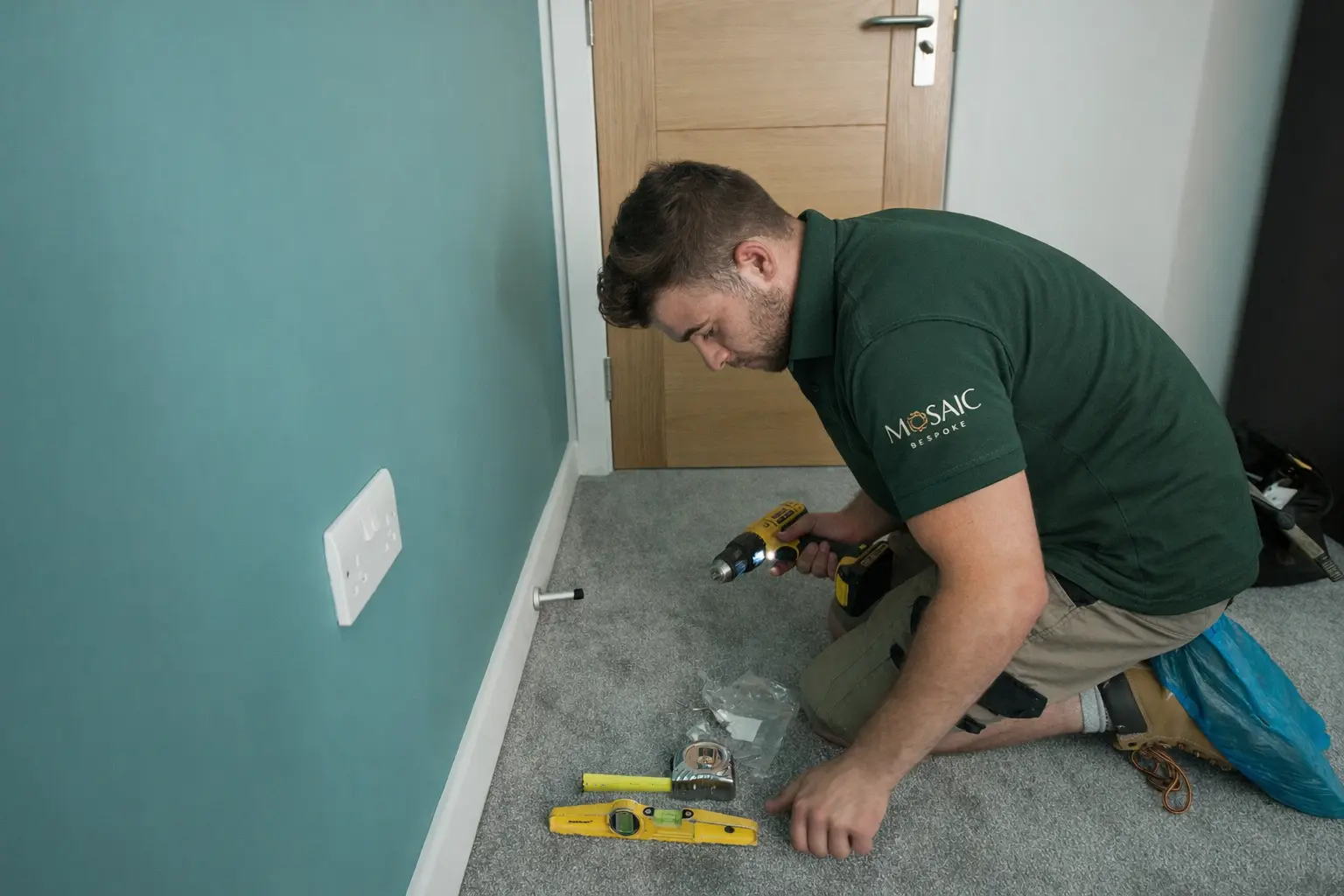 Mosaic Bespoke carpenter hanging a door on site