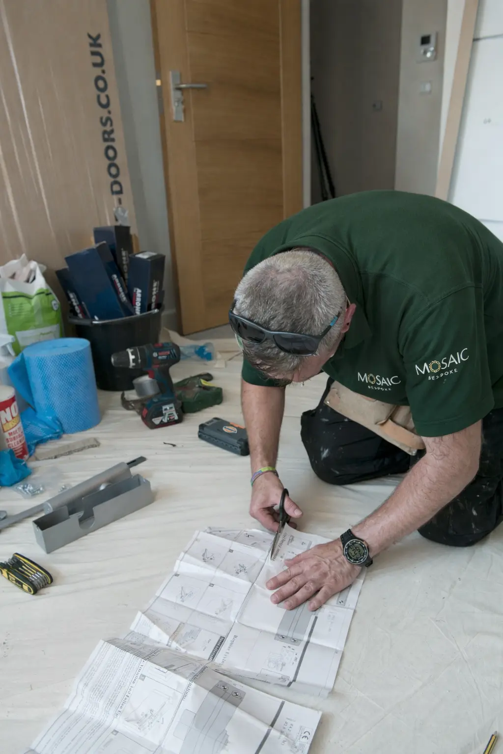 Mosaic Bespoke team member checking drawings against the works